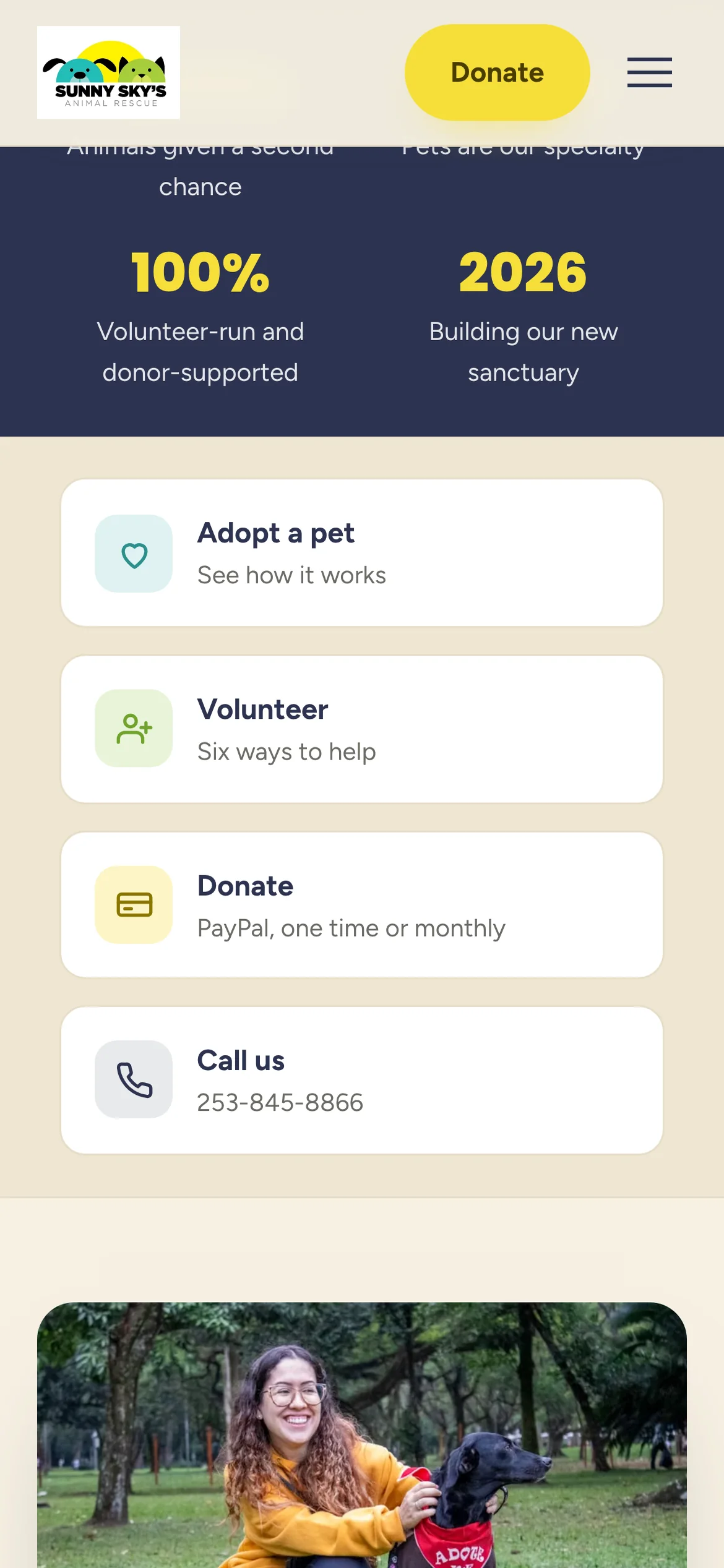 Sunny Sky's on a phone: the two figures, then the four action cards stacked, Adopt a pet, Volunteer, Donate and Call us, each with an icon and a line of description.